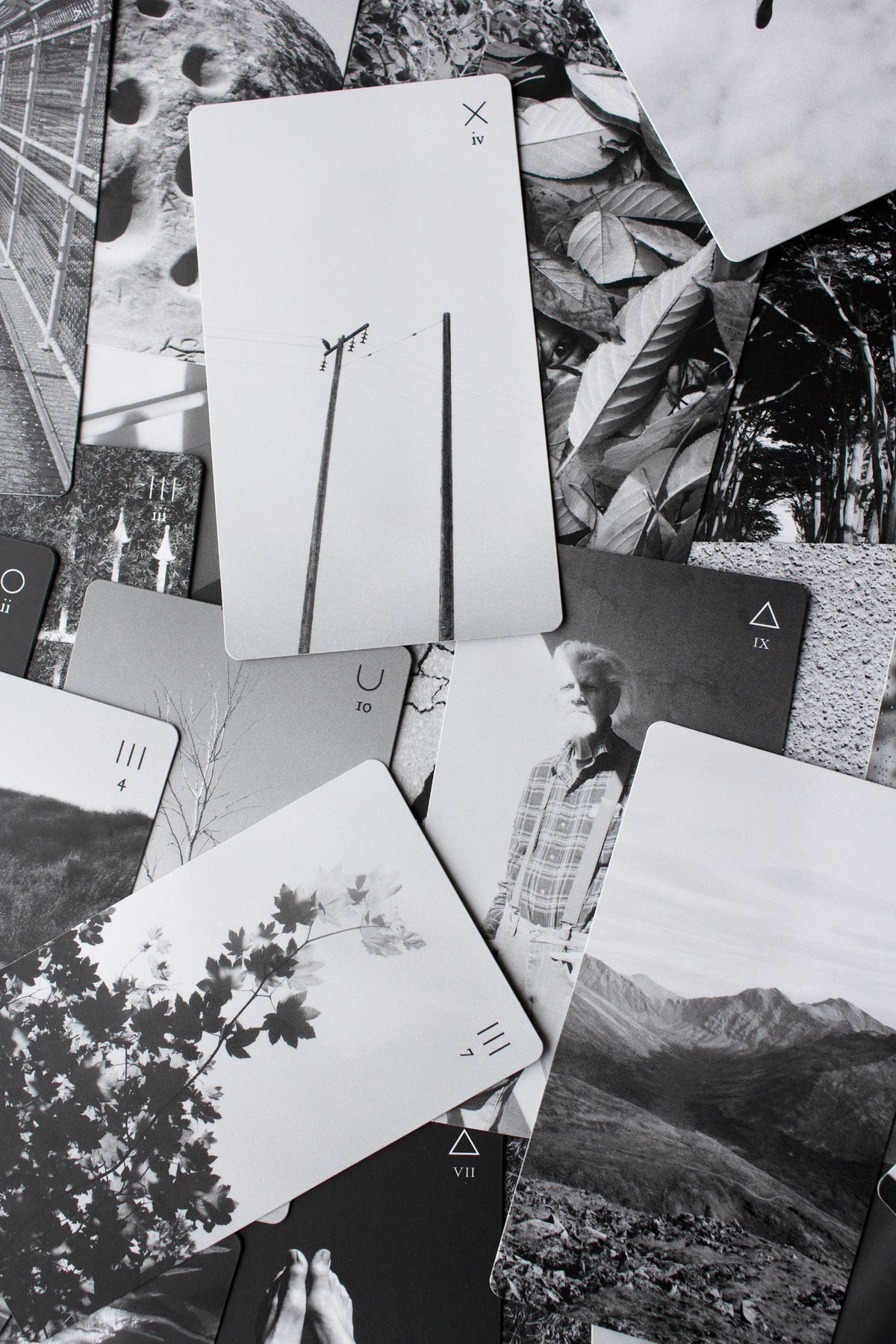 A spread of black-and-white photographic Tarot cards from Aaron Friend Lettner’s Book of Light.