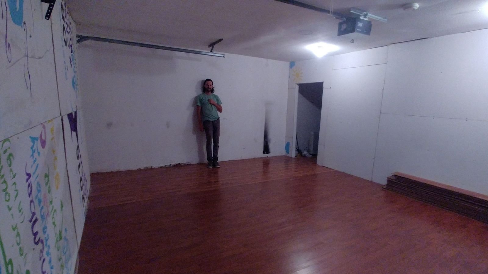A nearly completed CLOUD Studio interior with finished wood floor and newly enclosed white walls.