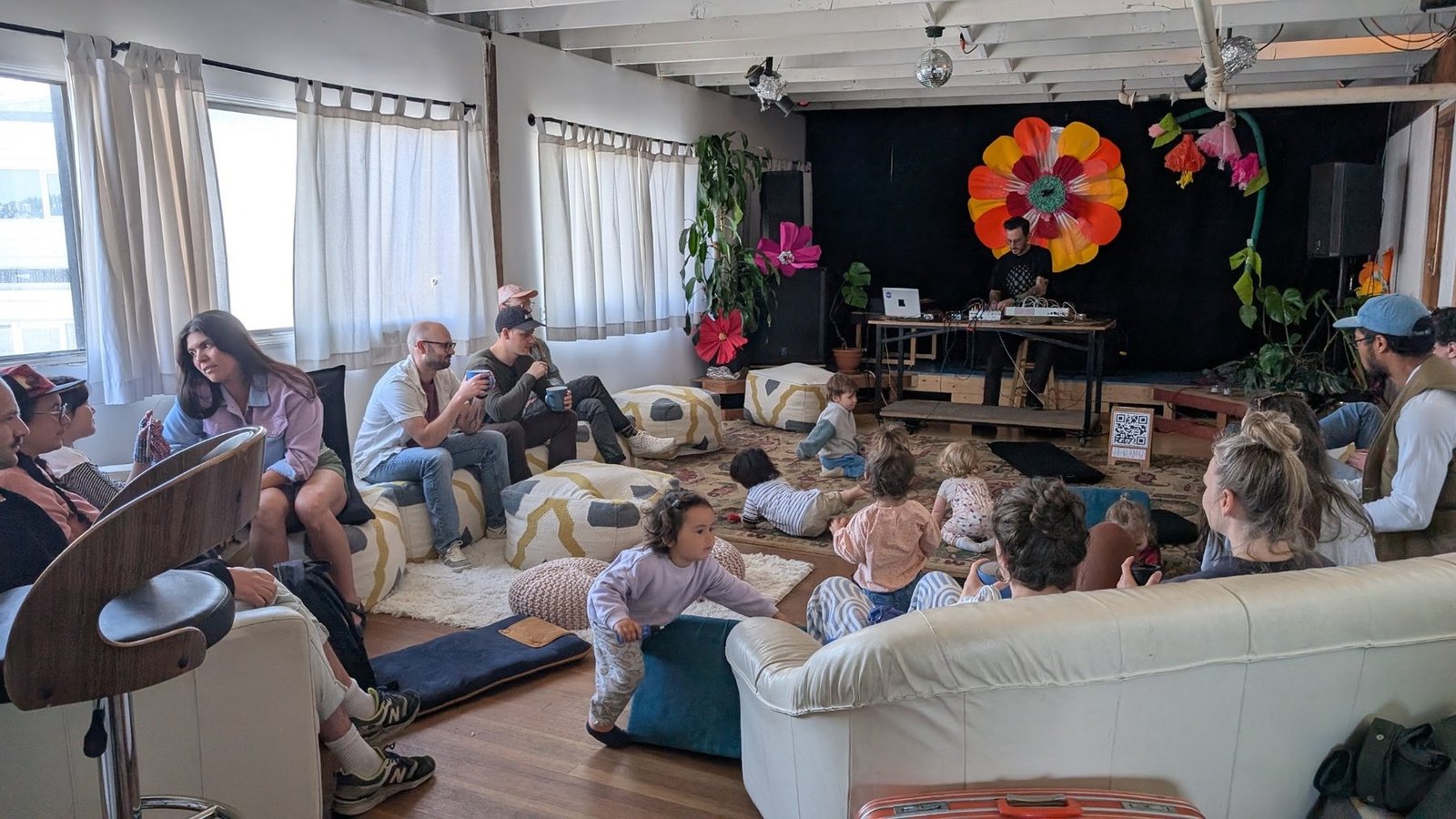 Audience members and children seated in the Hypha Arts main space during J.T. Gladysz’s performance.