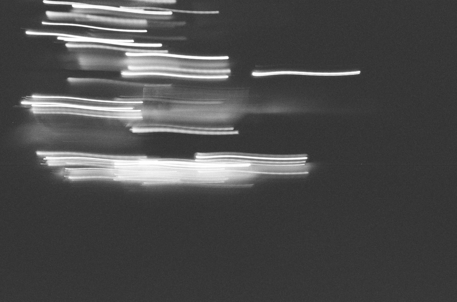Black-and-white long-exposure archival image with streaks of light, associated with Quiet Night Series.