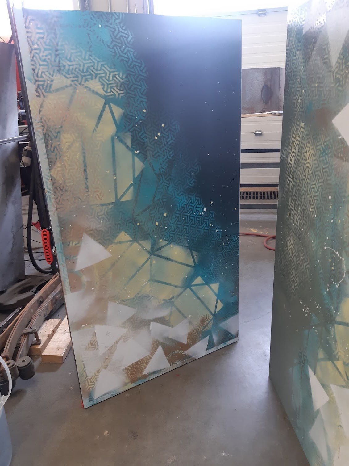 Two upright painted panels for the Sonic Ping-Pong project stand in a workshop during fabrication.