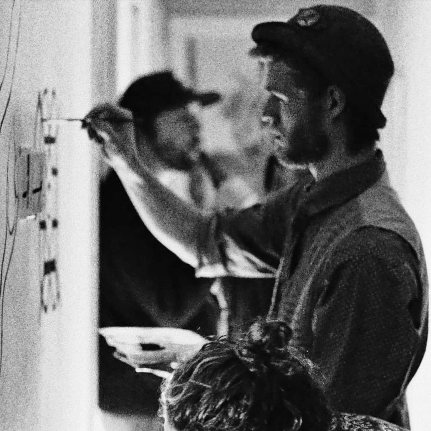 An artist painting on a wall in motion blur, holding a palette