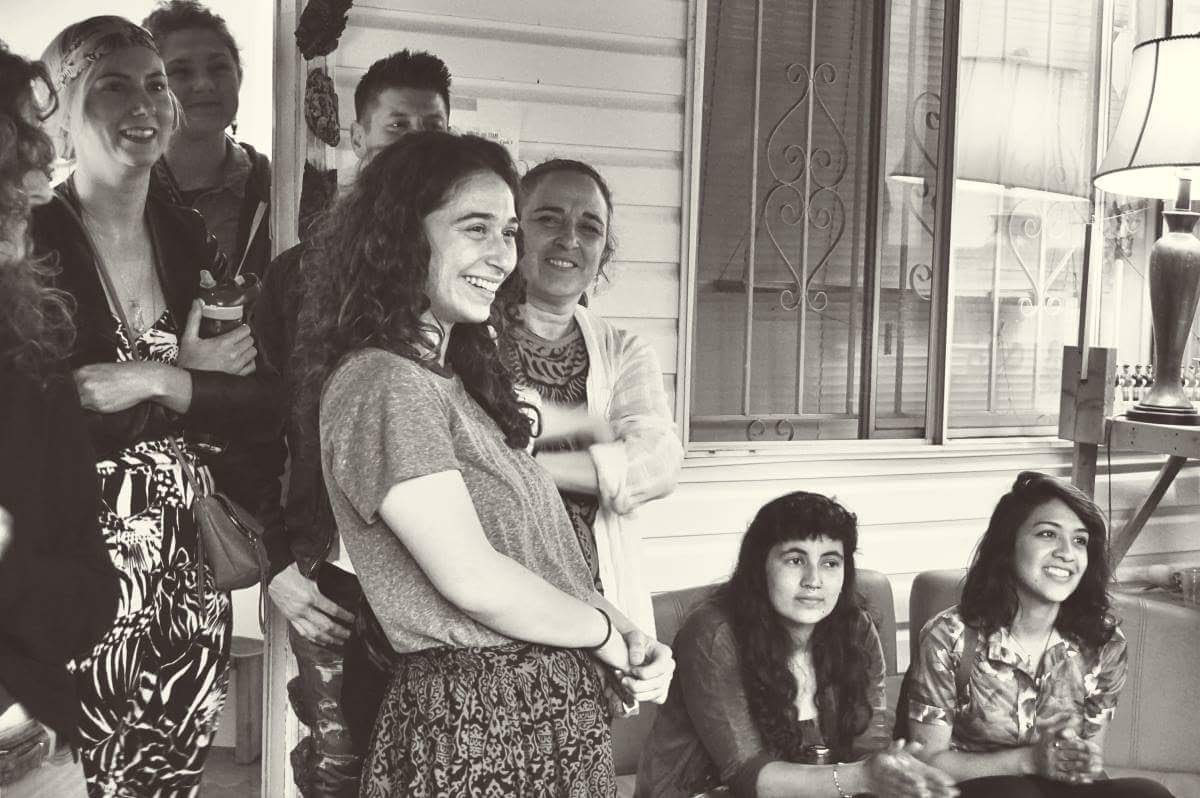 A group of people on the house's front porch during an event